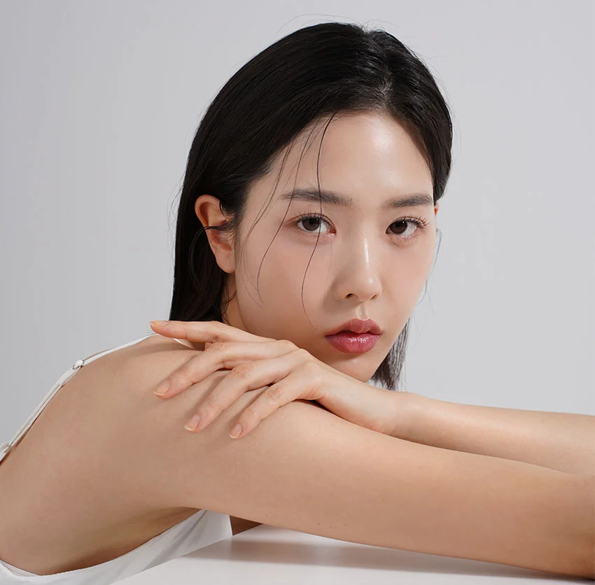 Woman with dark hair, resting her chin on her arm - Hydrafacial in Chino, CA